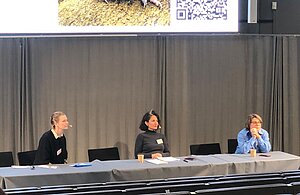 panelists are sitting by the table.